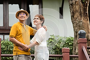 Image of happy romantic Asian senior couple outdoor in park