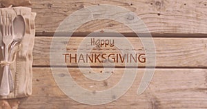 Image of happy thanksgiving day text over cutlery