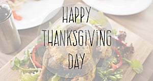 Image of happy thanksgiving day text over thanksgiving meal in background