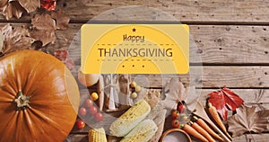 Image of happy thanksgiving day text over vegetables