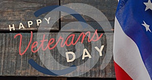 Image of happy veterans day text over american flag and wooden background