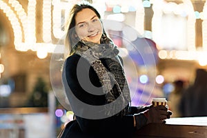 Image of happy woman in city at evening on blurred background