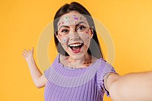Image of happy woman showing copyspace while taking selfie