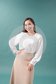 Image of happy young business woman posing isolated over blue wall background