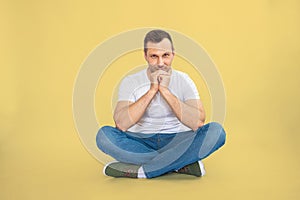 Image of a happy young Caucasian man posing isolated over yellow background.