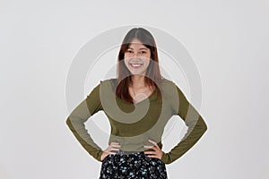 Image of happy young girl standing and Looking camera pointing isolated over white background.