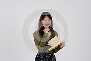 Image of happy young girl standing and Looking camera pointing isolated over white background.