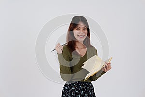 Image of happy young girl standing and Looking camera pointing isolated over white background.