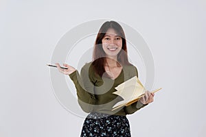 Image of happy young girl standing and Looking camera pointing isolated over white background.