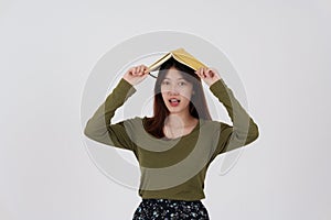 Image of happy young girl standing and Looking camera pointing isolated over white background.