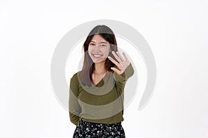 Image of happy young girl standing and Looking camera pointing isolated over white background.