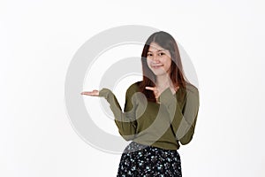 Image of happy young girl standing and Looking camera pointing isolated over white background.