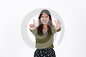 Image of happy young girl standing and Looking camera pointing isolated over white background.