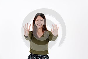 Image of happy young girl standing and Looking camera pointing isolated over white background.