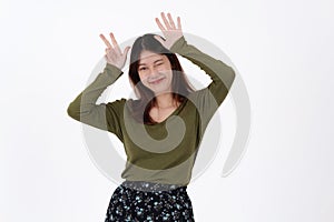 Image of happy young girl standing and Looking camera pointing isolated over white background.