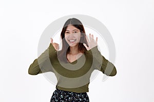 Image of happy young girl standing and Looking camera pointing isolated over white background.