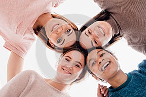 Image of a happy young women multiracial friends posing isolated over white wall background looking at camera.