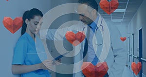 Image of heart icons falling over diverse doctors talking photo