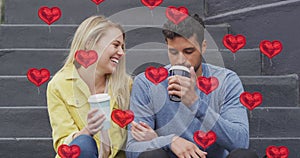 Image of heart icons floating over happy caucasian couple talking and drinking takeaway coffee