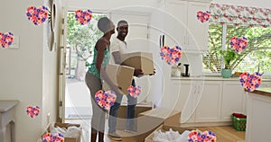 Image of heart icons with flowers over african american couple moving house