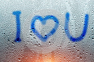 Image of a heart and a question mark on a wet misted window. Emo