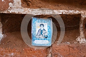 The image of the holy martyr, inserted into a niche in the brick wall