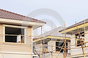 Image of home construction process with wooden bamboo scaffolding on construction site for property presentation and report