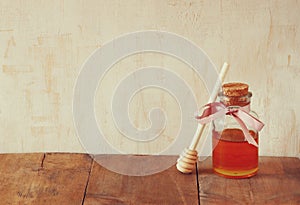 Image of honey glass jar. rosh hashanah (jewish holiday) concept. traditional holiday symbols.