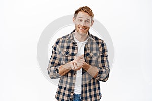 Image of hopeful redhead man smiling, rub hands and asking for favour, begging for help, need something, lending money