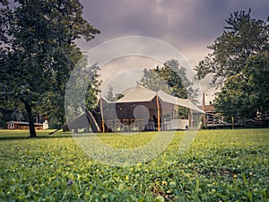 Image of huge white tent for a wedding event in the nature