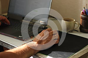 Image of human hands pressing keys of laptop