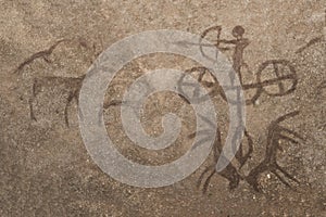 An image of a hunting scene of an ancient man on a cave wall.