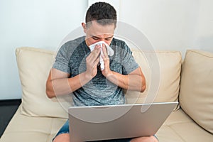 Image of an ill man blowing his nose