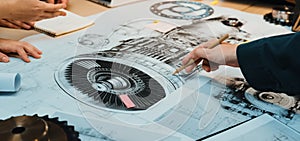 Detailed Technical Drawing Analysis of Mechanical Components with Engineering Team Collaborating in Workshop Environment