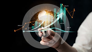 Business growth concept with light bulb representing innovation and investment in data analysis, featuring charts and