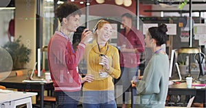 Image of infographic interface and diverse happy colleagues drinking coffee and talking in break
