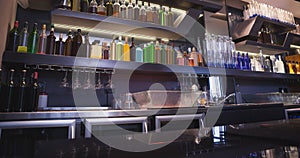 Image of interior of bar with rows of bottles