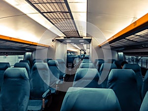 Image with the interior of a china border train. A modern train with comfortable and colorful chairs