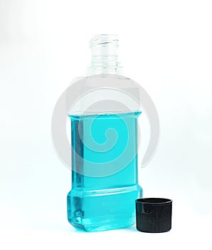 An image isolated clear blue mouthwash in clear plastic bottles is a chemical solution for cleaning your mouth in the morning or a