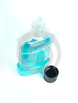 An image isolated top view clear blue mouthwash in clear plastic bottles is a chemical solution for cleaning your mouth in the