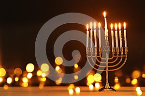 image of jewish holiday Hanukkah background with menorah & x28;traditional candelabra& x29; and candles. photo
