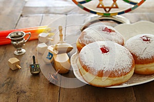 image of jewish holiday Hanukkah background with traditional spinnig top, doughnuts and menorah