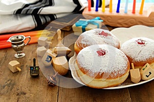 image of jewish holiday Hanukkah background with traditional spinnig top, doughnuts and menorah