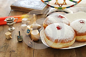 image of jewish holiday Hanukkah background with traditional spinnig top, doughnuts and menorah