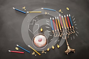 Image of jewish holiday Hanukkah background with traditional spinnig top, menorah (traditional candelabra) and burning candles.