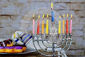 image of jewish holiday Hanukkah with menorah traditional Candelabra , donuts