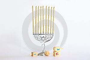 Image of jewish holiday Hanukkah with wooden dreidels spinning top isolated on white