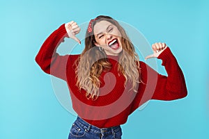 Image of joyful caucasian woman laughing and pointing fingers herself