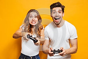 Image of joyful man and displeased woman playing together video