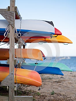 Image of kayaks stored on the beach.